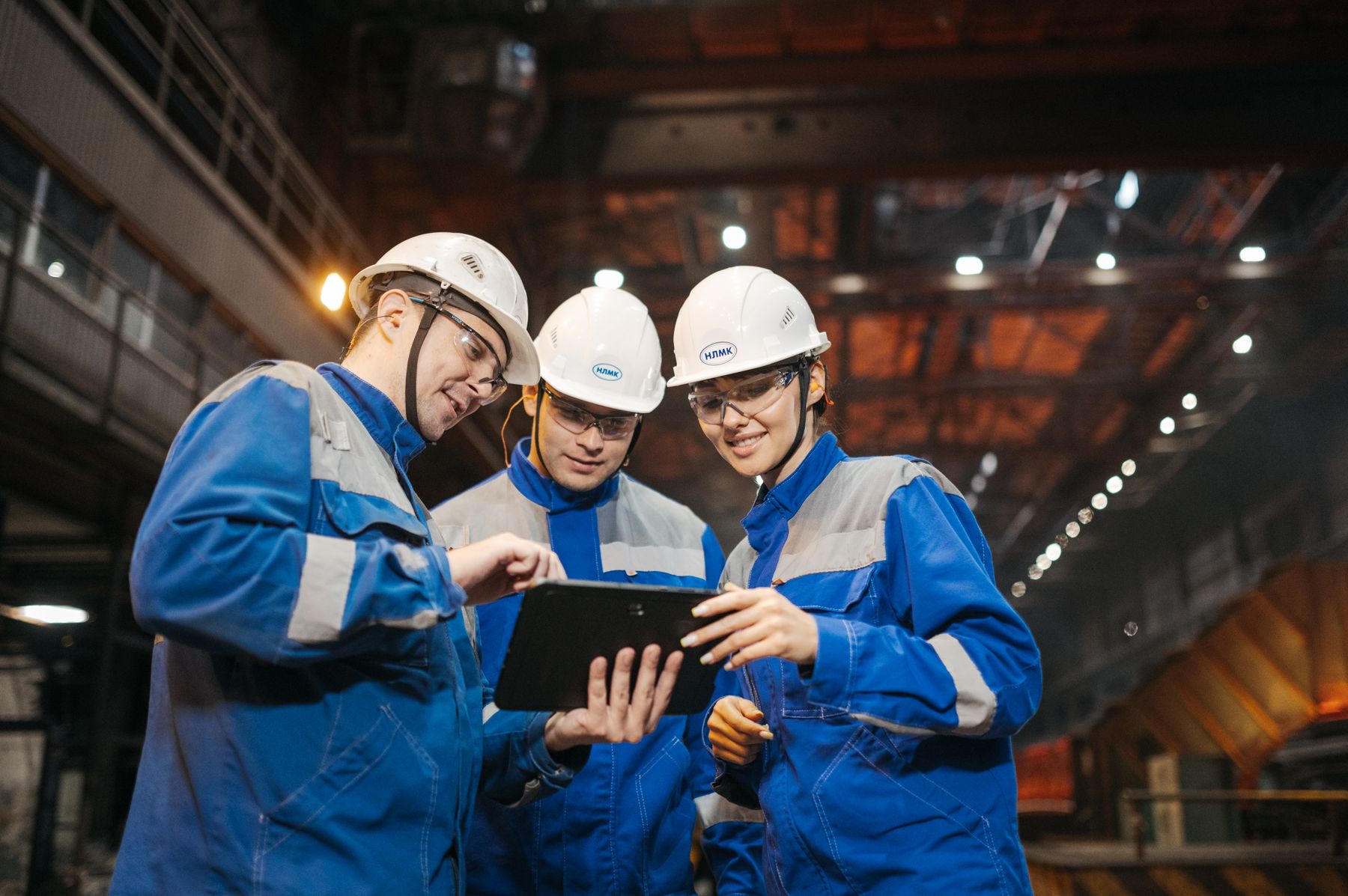 Industrial engineering team reviewing work together on a factory floor